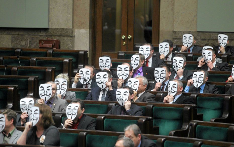 Members of the Ruch Palikota Party wear masks during a vote of no confidence for health minister Bar