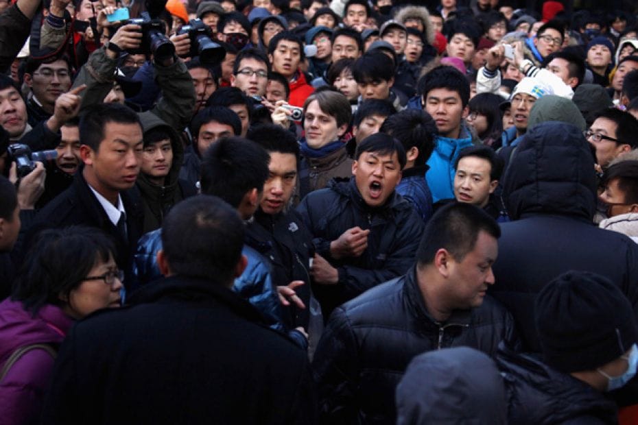 A man yells at a security guard after the guard tried to remove a member of the crowd at the Apple s