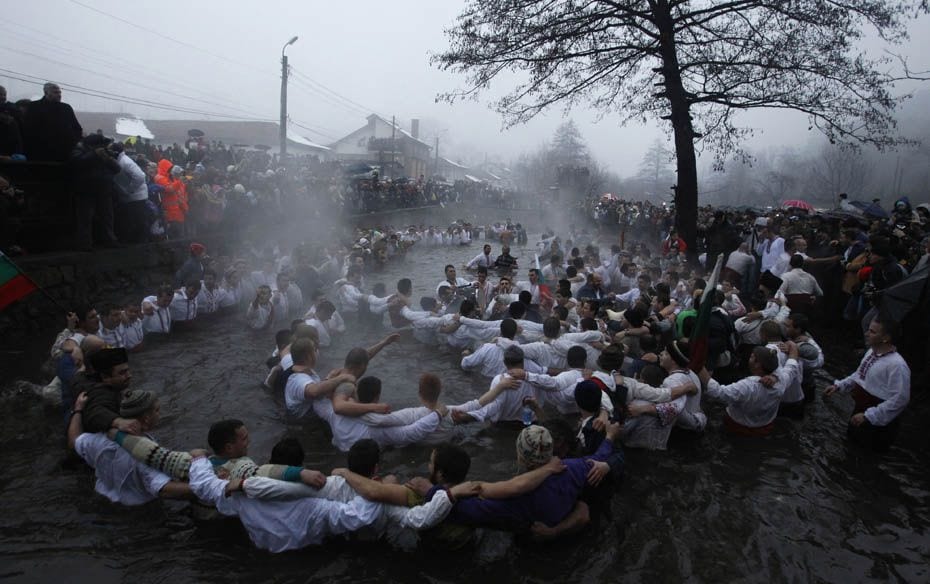 Bulgarian men dance in the icy waters of the Tundzha river during a celebration for Epiphany Day in 