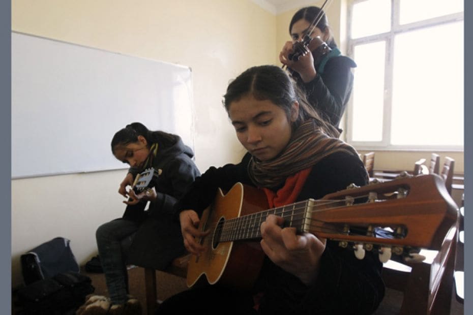 Female students play guitars and a violin at the Kabul Music Academy. In Afghanistan's sole musi