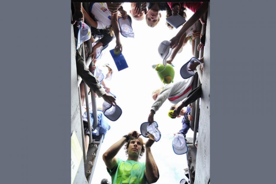 Tennis star Rafael Nadal of Spain signs autographs during a practice session before the Australian O