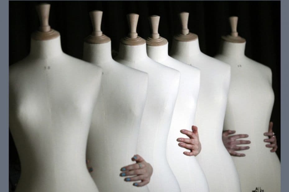 Fashion students hold plus size mannequins during a photocall for their unveiling at Edinburgh Colle