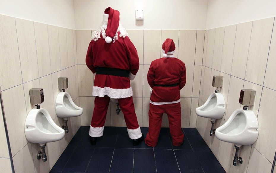 Two men dressed as Santa Claus use a toilet in Citta' Sant'Angelo near Pescara. A group of p