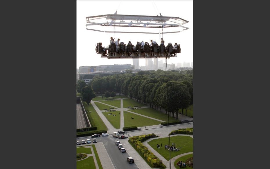 Guests enjoy a ‘Dinner in the Sky’ on a platform hanging in front of the Cinquantenaire 