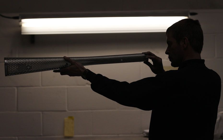 A worker inspects a part-made London 2012 Olympic Games torch at the Premier Group Factory in Covent