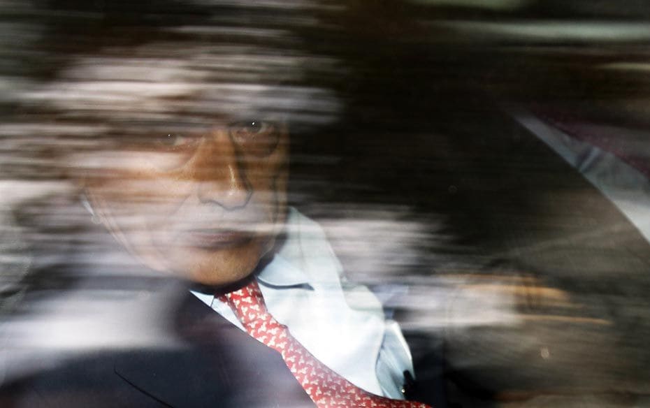 Rajat Gupta seen through his car window after posting bail at Federal Court in New York October 26, 