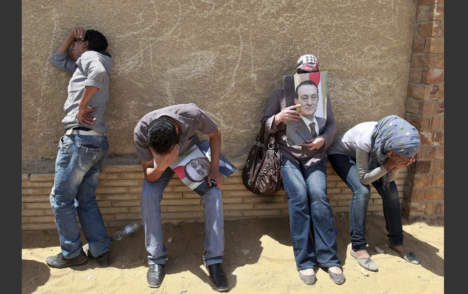 Supporters of deposed president Hosni Mubarak react after a court sentenced him to life in prison, o