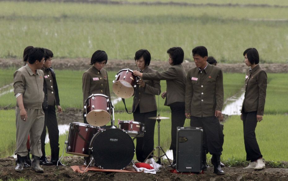 Members of a music group check a drum after performing at Hwanggumpyong Island, North Korea         