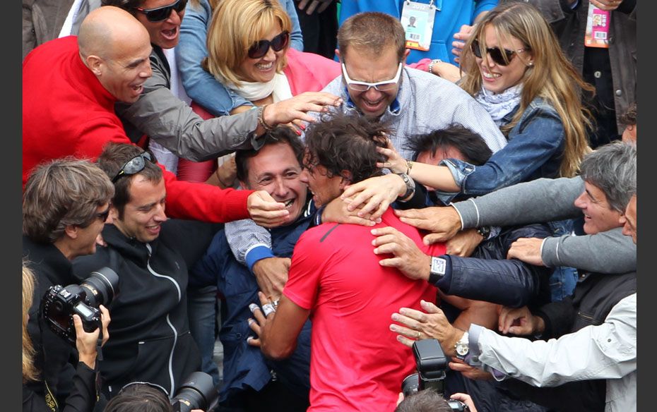 Rafael Nadal of Spain (C) celebrates with staff members and family after winning the men's singl