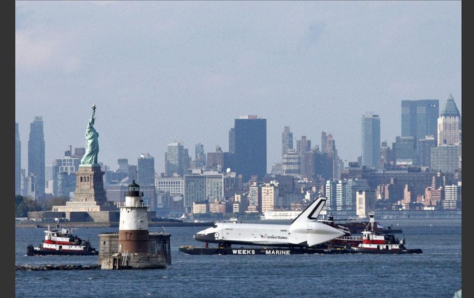 The lower Manhattan skyline and Statue of Liberty are seen behind the Space Shuttle Enterprise in Ne