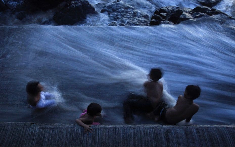 Children play as seawater rushes onto the steps of the Haji Ali Shrine in Mumbai, June 13, 2012     