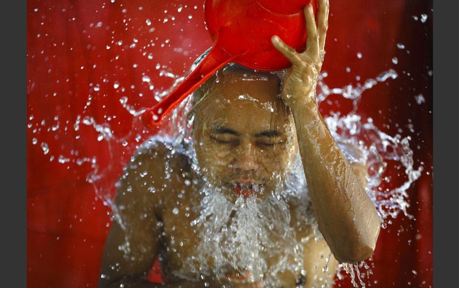 A Buddhist monk takes a bath inside a monastery in Yangon, Myanmar                        