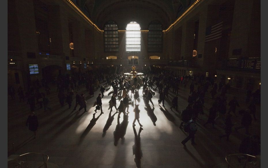 Morning commuters are silhouetted as they walk through the main concourse of the Grand Central Stati