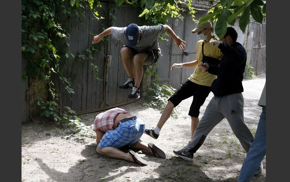 Unidentified people beat Svyatoslav Sheremet (L, bottom), head of Gay-Forum of Ukraine public organi