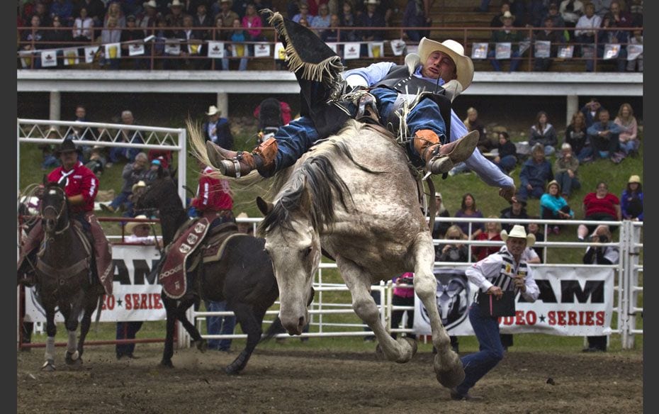 Jake Vold of Ponoka, Alberta rides a bronco during the 94th Annual Falkland Stampede in Falkland, Br