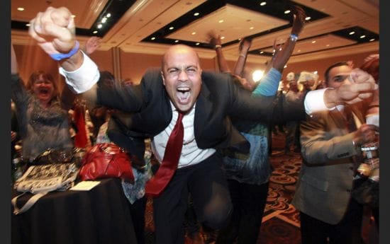 Ajay Narayan cheers as the race is called for U.S. President Barack Obama by a television network du