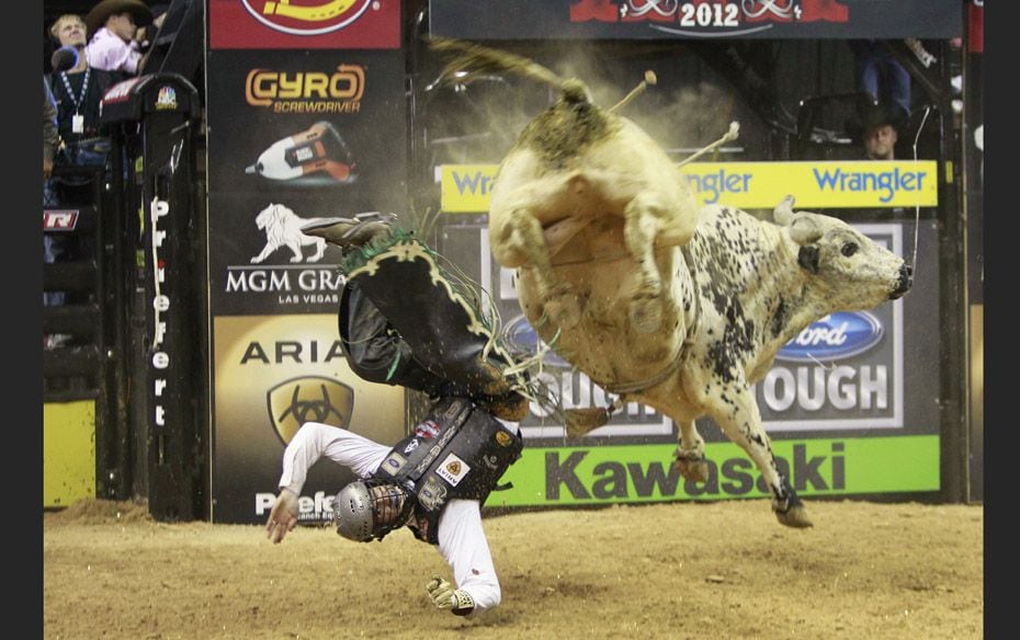 Jordan Hupp of the US gets thrown off a bull during the Built Ford Tough Series Professional Bull Ri