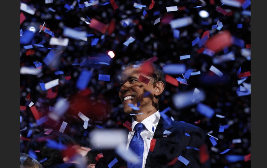 US President Barack Obama celebrates on stage as confetti falls after his victory speech during his 