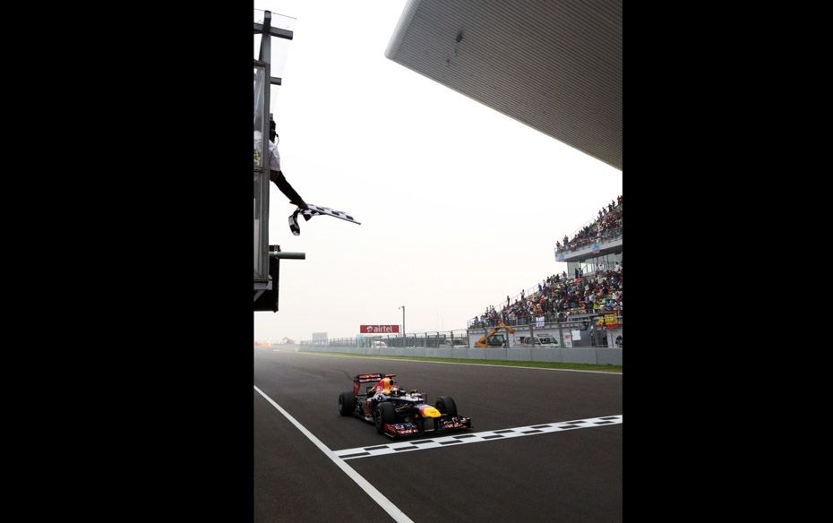 Sebastian Vettel (GER) Red Bull Racing RB8 crosses the line to win the race                        