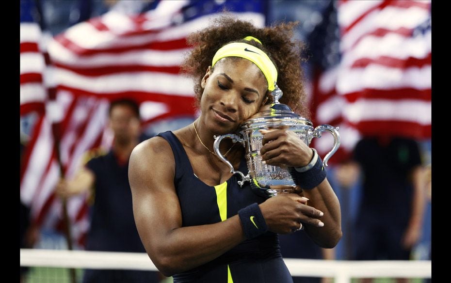 Serena Williams of the US poses with her trophy after defeating Victoria Azarenka of Belarus in thei