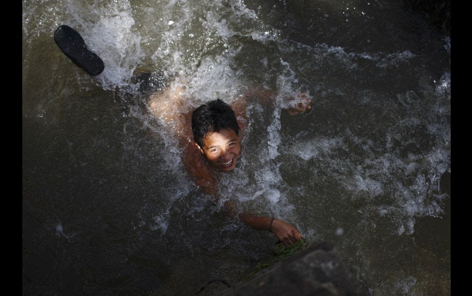 A boy swims in the Triveni River at Panauti in Kavre, on the outskirts of Nepal's capital Kathma