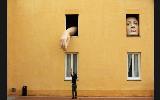 A woman takes pictures of an art installation "Alice" by Spanish artist Cristina Lucas in 