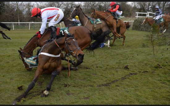 Jockey Davy Condon (L, in white) struggles to stay on board Jamsie Hall at the 11th fence in the fou