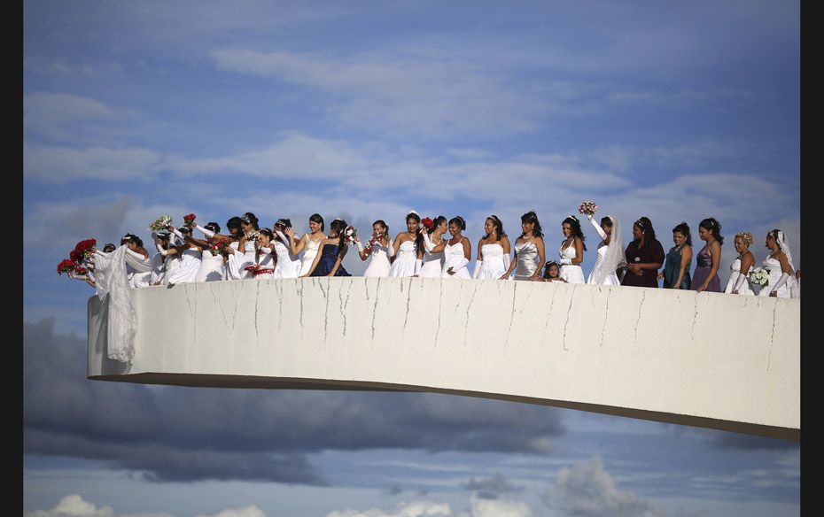 Brides pose for photos before their mass wedding ceremony at the Museum of the Republic in Brasilia 