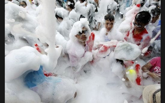 Revellers enjoy foam and splashing water during Songkran Festival celebrations in Bangkok on April 1