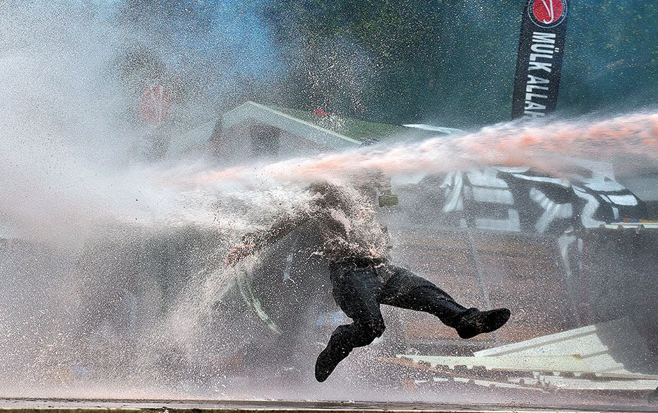 A protestor is hit by water sprayed from a water cannon in Taksim Square, Istanbul, in June. The cit