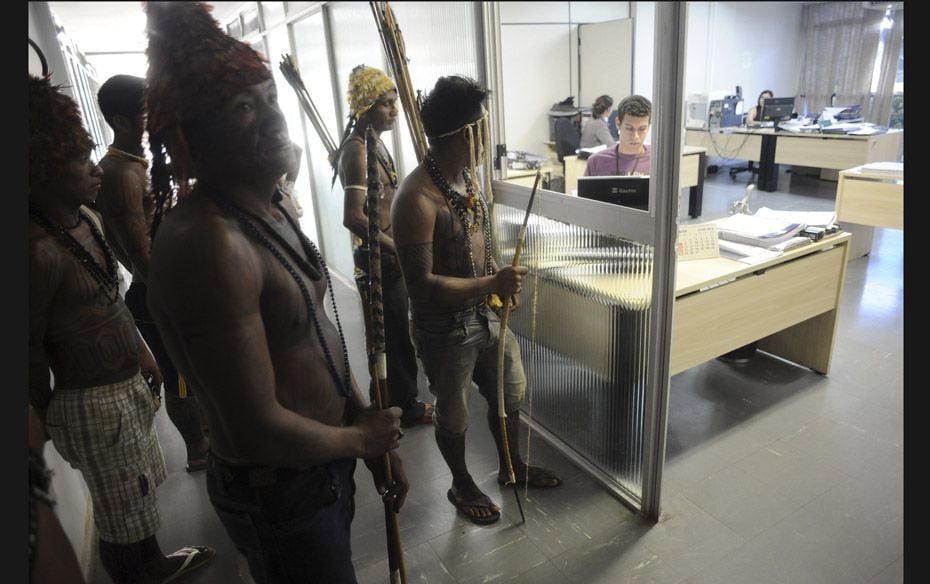 Munduruku Indians stand guard at the offices of the Brazil's Indian affairs bureau (FUNAI) headq