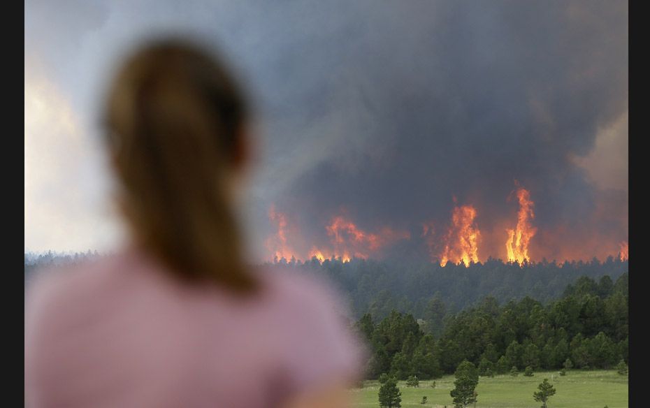 Melisa Dohl watches a wall of flame as it rages through Black Forest, Colorado on June 12. Fire crew