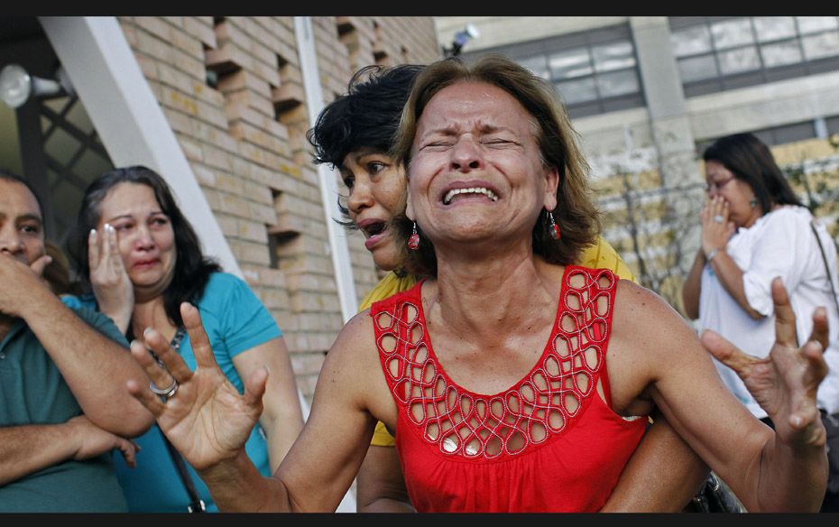 Supporters of Venezuela's President Hugo Chavez react to the announcement of his death on March 