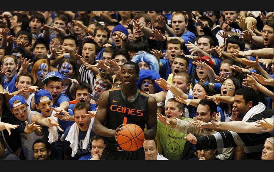 The University of Miami's Durand Scott looks to make an in-bounds pass as he is taunted by Duke 