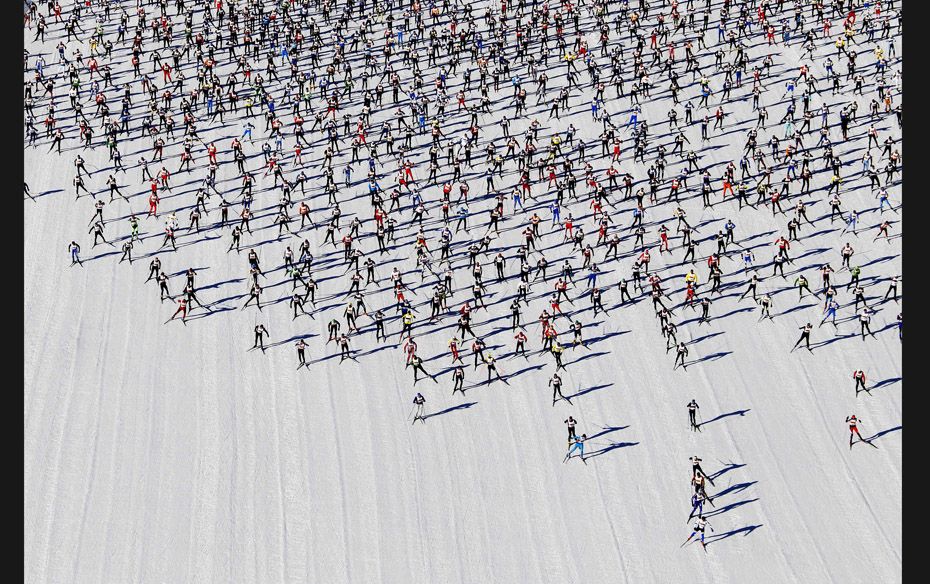 Cross-country skiers start during the Engadin Ski Marathon on the frozen Lake Sils near the village 