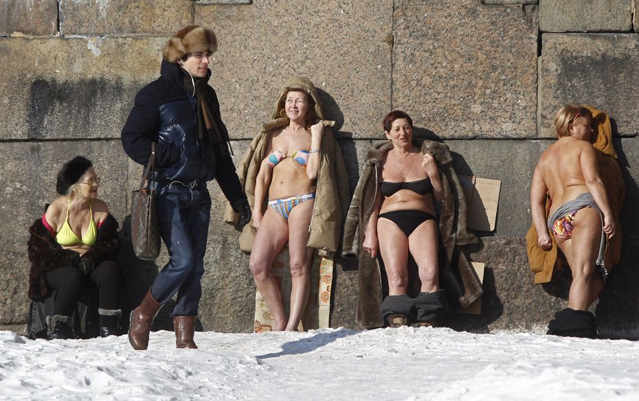 People sunbathe by the wall of the Peter and Paul Fortress in St. Petersburg, Russia on March 10    