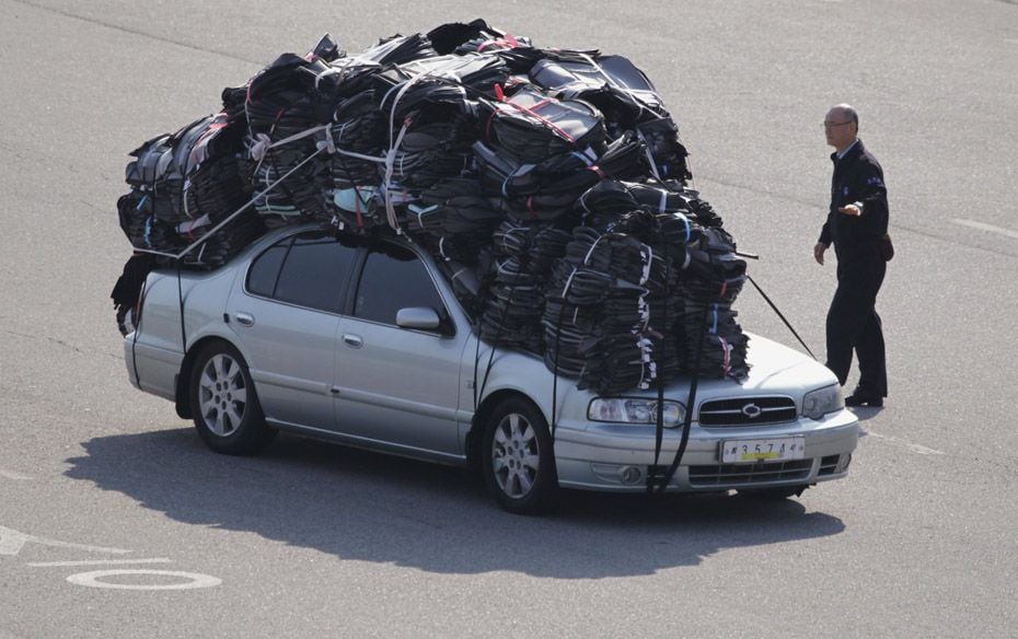 A customs officer checks as a vehicle of a South Korean company carrying products made in inter-Kore