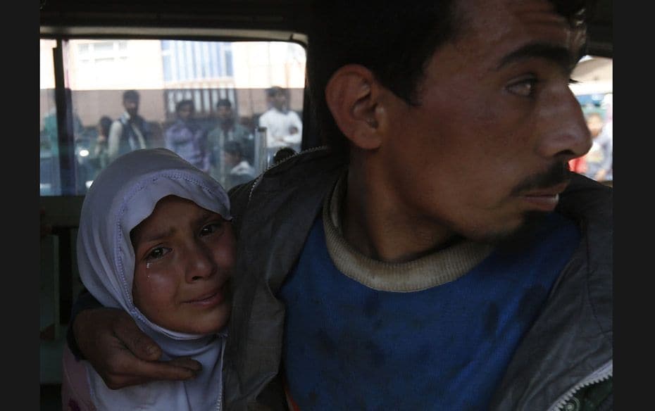 A schoolgirl who fell ill after smelling gas at her school, cries inside an ambulance in Kabul on Ma