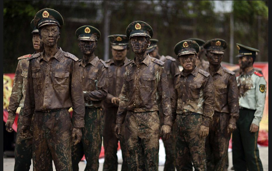 Paramilitary policemen stand guard during Monihei Carnival in Cangyuan county, Yunnan province on Ap