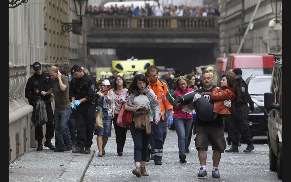 Injured people leave an area after an explosion in Prague on April 29. The explosion in central Prag