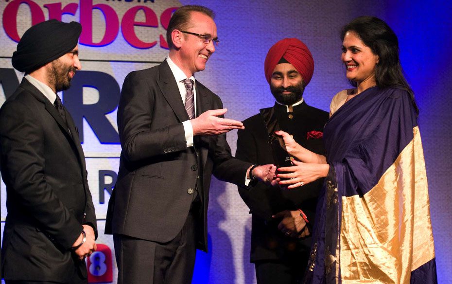 Sonal Singh, head of sales, Christies India, receives the Auction of the Year award from Louis Saile