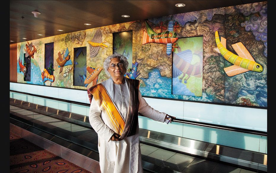 Rajeev Sethi, the curator standing in front of artwork created by Gond artists of Madhya Pradesh    