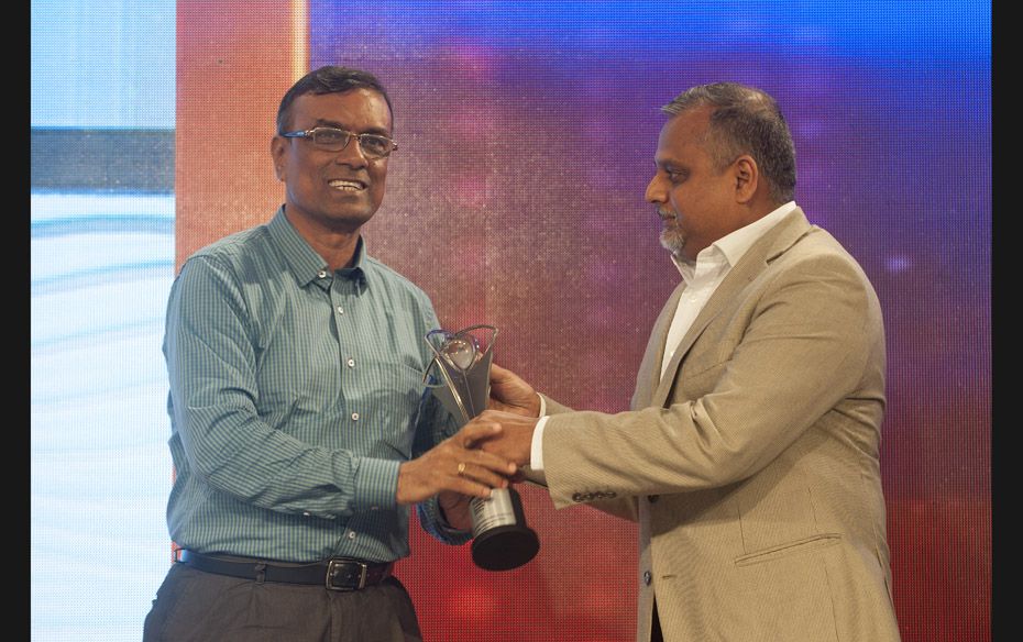 Chandra Shekhar Ghosh (left), founder of Bandhan, receives the 'Entrepreneur with Social Impact&