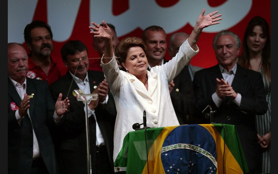 Brazil's President and Workers' Party (PT) presidential candidate Dilma Rousseff acknowledge