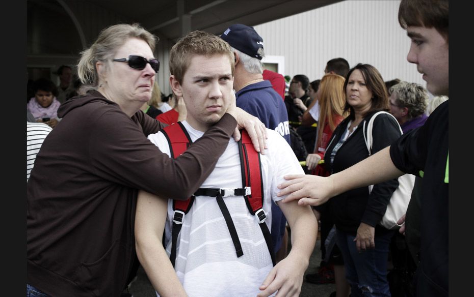 Shocked students and parents gather at the Shoultes Gospel Hall church on October 24, after a studen