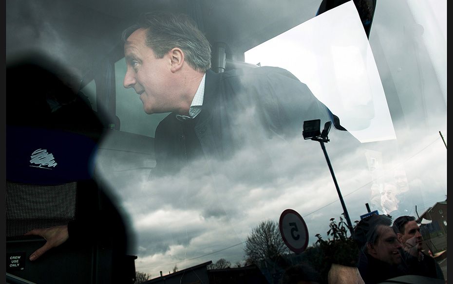 Britain's Prime Minister David Cameron boards the "battle bus" after talking to suppor