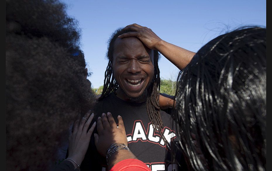 Muhiyidin Moye D'Baha of the Black Lives Matter movement, leads his group in prayer before a new