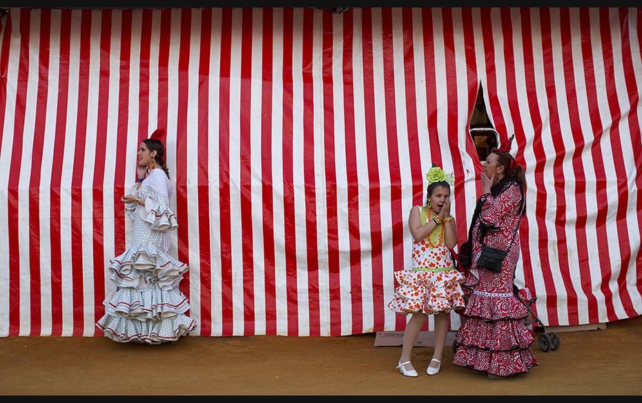 Women wearing sevillana dresses are seen during the traditional Feria de Abril (April fair) in the A