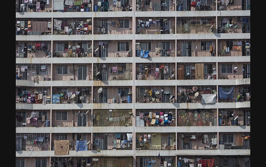 Windows of various apartments of a high-rise residential building are seen in the western suburb of 