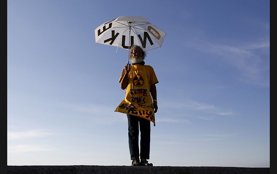 Mitsuro Sudo, 66, poses for a photograph during a protest near Kyushu Electric Power's Sendai nu